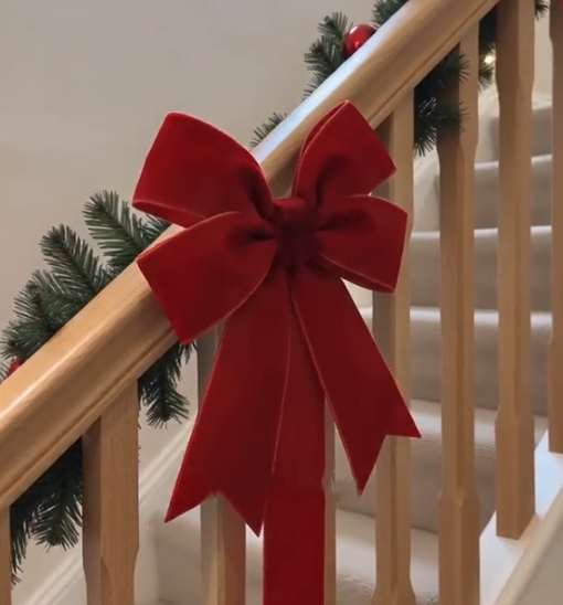 Burgundy bow decorating a stair railing
